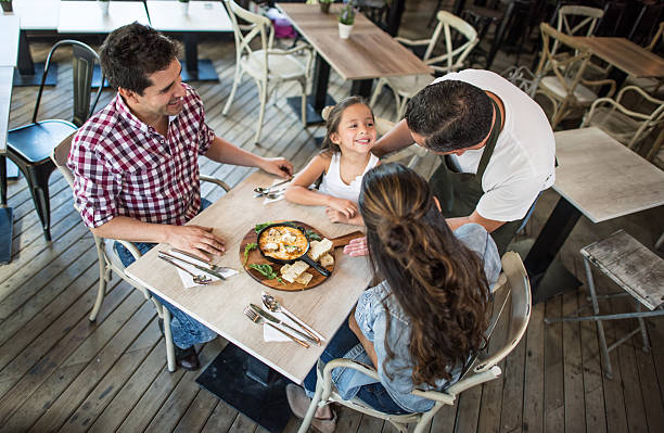 istock Happy family eating at a restaurant 584870728