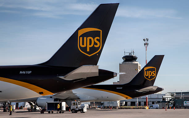 UPS Airlines at Canada's Winnipeg International Airport Winnipeg, Canada – July 20, 2016: Two UPS Boeing-757 Cargo Freighters sit on the ramp at Winnipeg James Armstrong Richardson International Airport with the Air Traffic Control Tower in the background UPS freight stock pictures, royalty-free photos & images