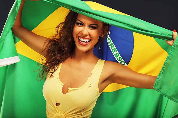 istock Happy Brazilian fan cheering with flag 584870842