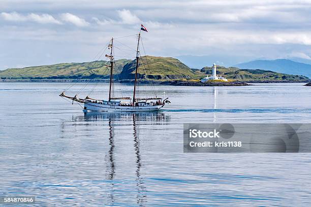 Sailing Boat In Front Of Eilean Musdile Lighthouse Stock Photo - Download Image Now - Lismore - Scotland, Lighthouse, Argyll and Bute
