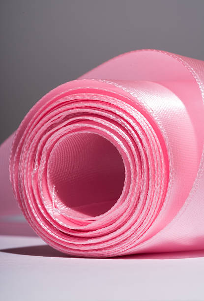 istock Hank silk pink  ribbon, close-up, macro on a grey 584871740