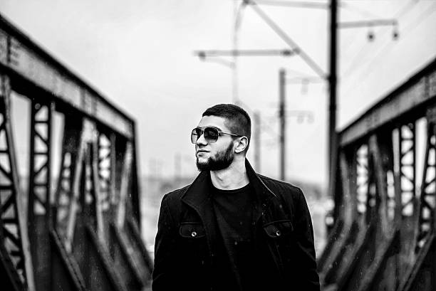 istock Man with beard walking on the railway 584872366
