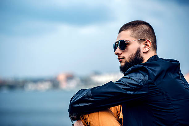 istock Man with beard outdoor with lake behind 584872664