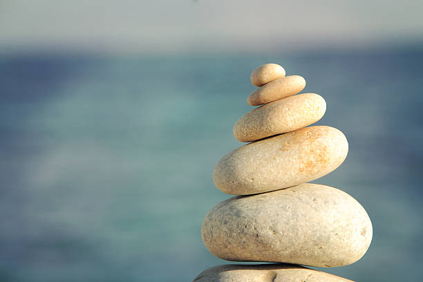 istock Pyramid of stones for meditation lying on sea coast 584873254