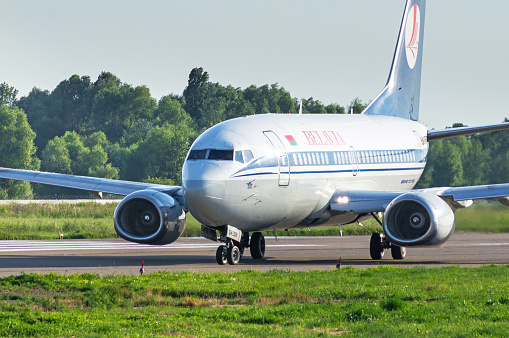 Kyiv, Ukraine - July 12, 2016: Commercial jet airplane  Boeing 737-524 by Belavia Airlines (EW-252PA) is taxiing for take off at International Airport Kyiv (IEV). Airplane front view. Aviation copy space background.