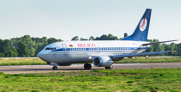 Kyiv, Ukraine - July 12, 2016: Airplane Boeing 737-524 by Belavia Airlines (EW-252PA) at airfield in Kyiv International Airport Zhuliany (IEV, Ukraine). White narrow body airplane on the runway before take off. Aviation copy space background.