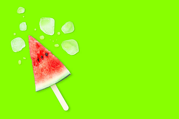 istock Slice of watermelon with ice cubes on a green background 584874296