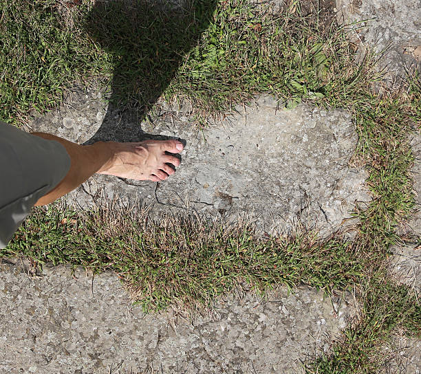 barefoot man walking on the stones