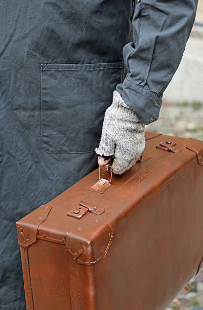 istock poor emigrated with leather suitcase and the glove during travel 584875594