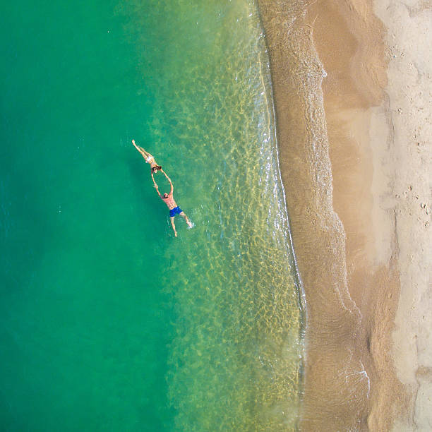 istock People on the beach by aerial view 584875596