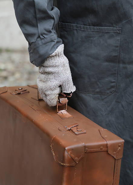 istock poor immigrant with old leather suitcase during the trip abroad 584876198