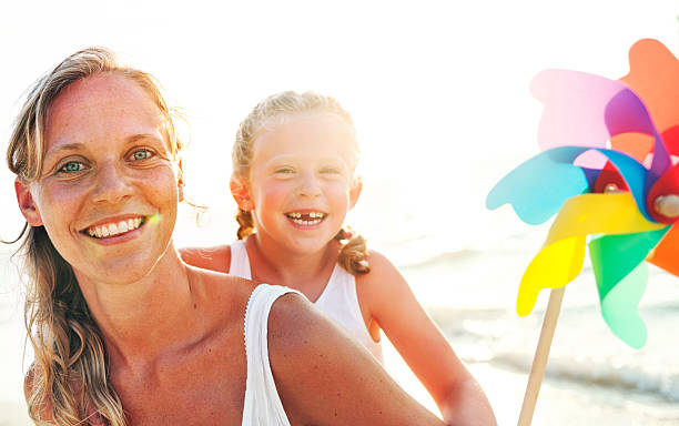 istock Mother Daughter Fun Happiness Beach Bonding Concept 584877902