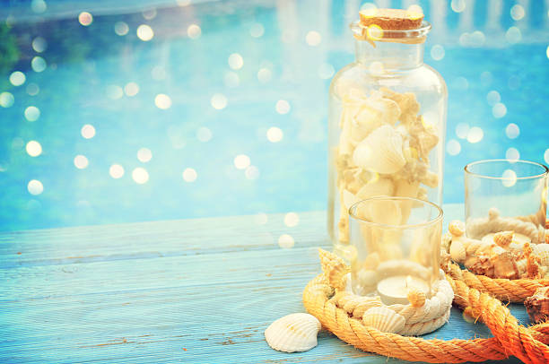 istock Summer outdoor decoration with sea shell and candles 584878340