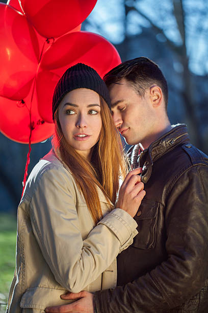 istock Happy young couple embracing outdoors 584879556