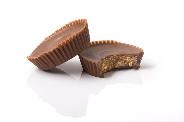 two peanut butter cups with bite - peanut butter imagens e fotografias de stock