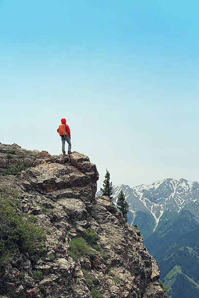 istock successful woman backpacke hiking  on mountain peak 584880208