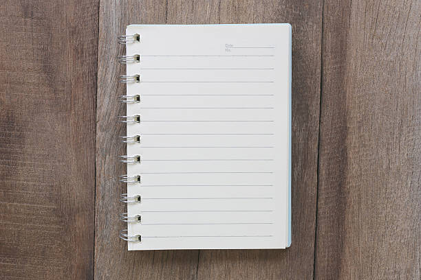 istock Notebook on old wood for the design background. 584880392