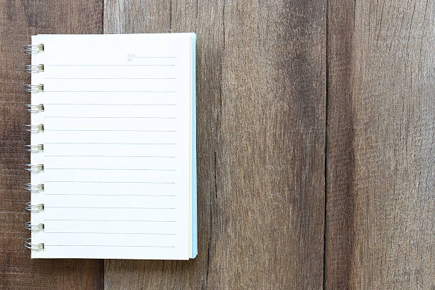 istock Notebook on old wood for the design background. 584880438