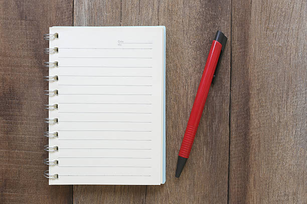 istock Notebook and pen on old wood for the design background. 584880648