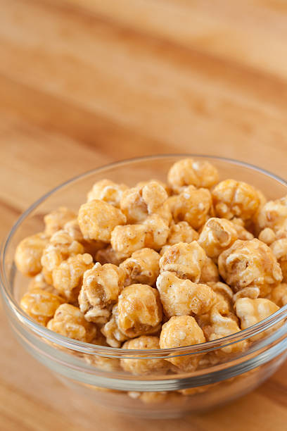 Glass bowl of caramel popcorn stock photo