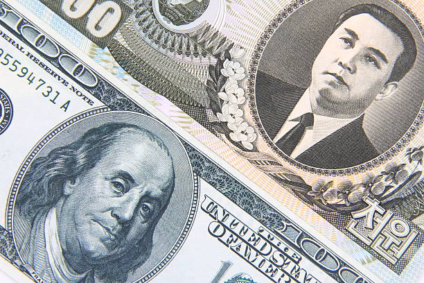 istock American and North Korean money 584881878