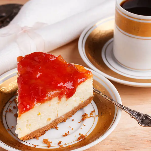 Cheesecake with brazilian goiabada jam of guava on white gold vintage plate with coffee. Selective focus