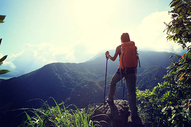 istock young woman backpacker enjoy the view on mountain peak 584884514