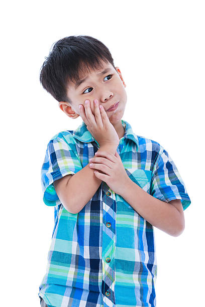 istock Asian handsome boy is having toothache. Isolated on white backgr 584884730