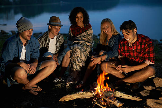 istock Friends sitting near campfire 584885806