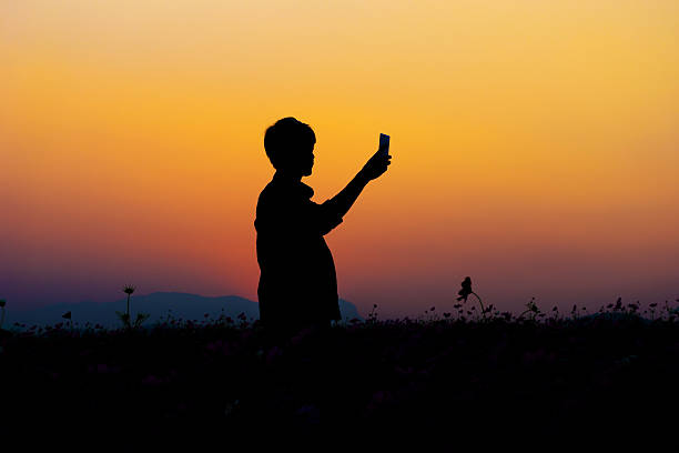 istock Silhouette of man posing at sunset sky background. 584885848