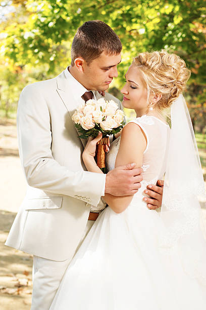 istock Beautiful young bride and groom in love. 584885954