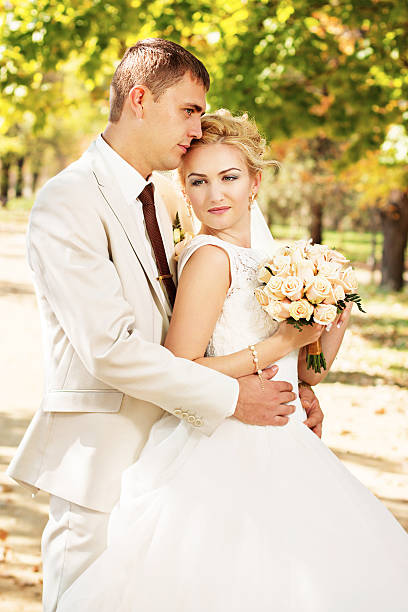istock Beautiful young bride and groom in love. 584886000
