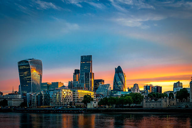 Skyline of The City in London, England at sunrise The City, one of the most important global financial center landmarks of the world, and the most important international business center in Europe, on the North bank of river Thames in London, England london stock pictures, royalty-free photos & images