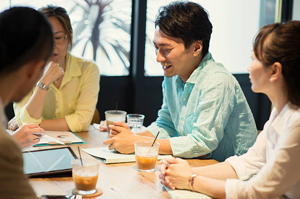 istock Four business people meeting in a cafe 584890100