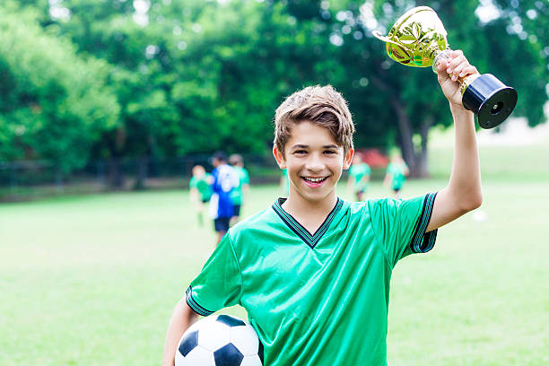 istock Happy boy celebrating his win at a soccer game 584890252