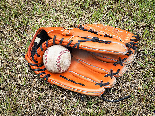 istock Nostalgic baseball in glove on a baseball field 584890316