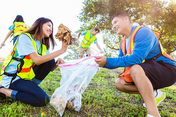 istock Happy couple participate in community cleanup day 584890674