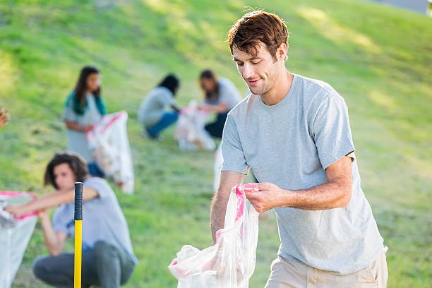 istock Man picks up garbage in the neighborhood 584890698
