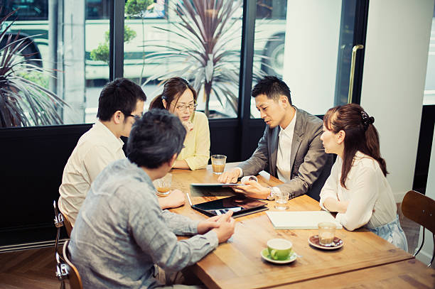 istock Five business people meeting in a cafe 584890888