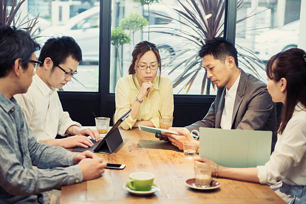 istock Five business people meeting in a cafe 584890926