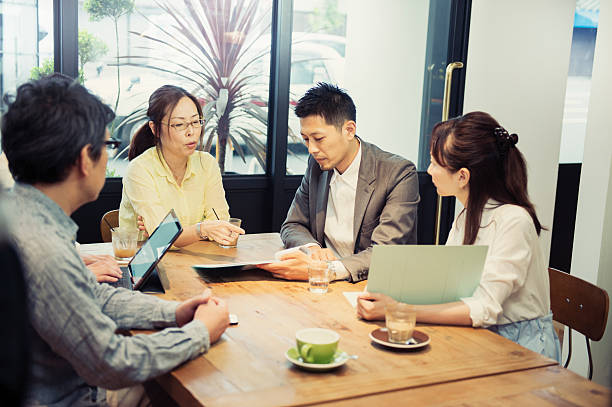 istock Five business people meeting in a cafe 584890972