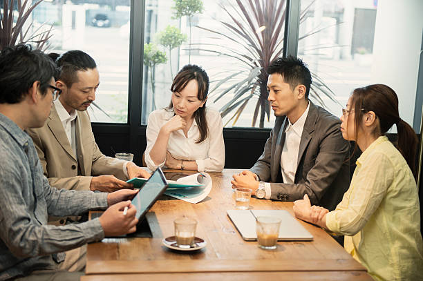 istock Five business people meeting in a cafe 584891082