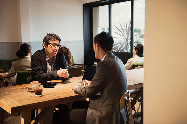 istock Two men in a casual meeting in a Cafe 584891596