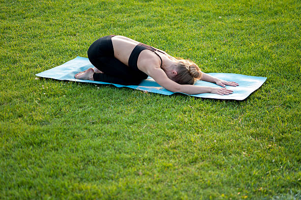 Slim Woman In Sportswear Doing Yoga On Green Grass Stock Photo - Download  Image Now - Active Lifestyle, Adult, Adults Only - iStock