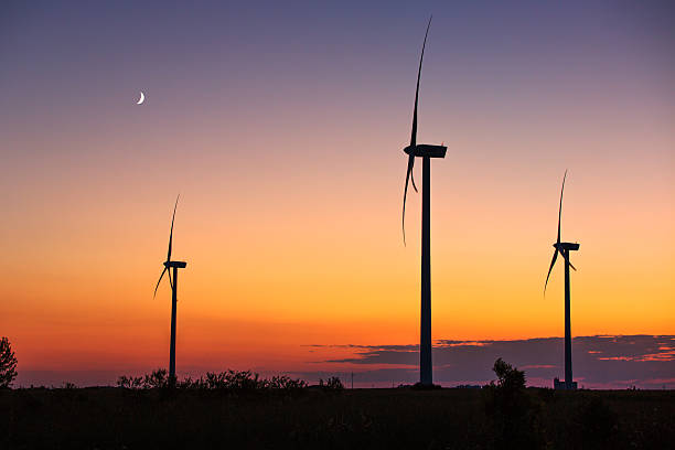 istock Wind turbine power generator silhouette at sunset 584892178