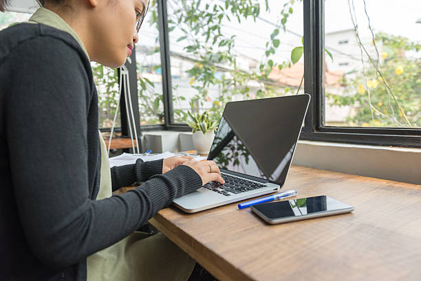 istock Lady working attentively on laptop at her lovely working-place 585047512