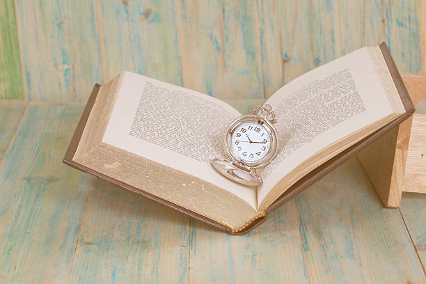 istock Pocket Watch over Age Book Background ,Time 585047868