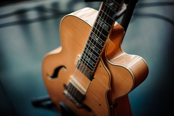 istock six-string acoustic guitar on a stand 585048686