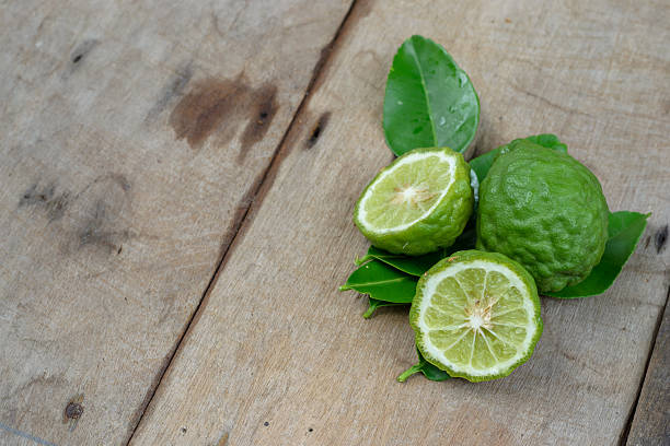 istock Bergamot with green leafs on wood background 585049414