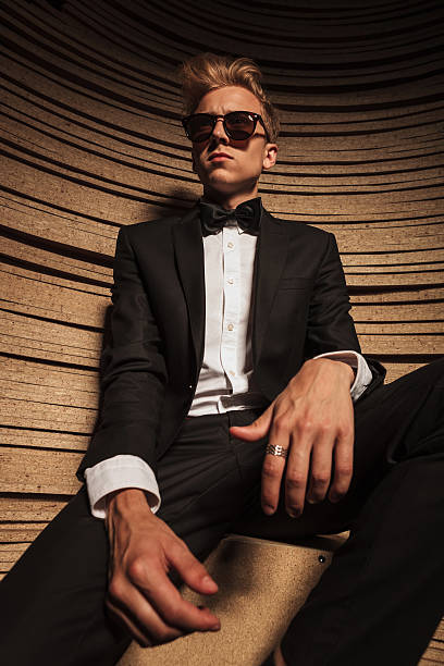 istock business man sitting while relaxing his hands on his legs. 585050062